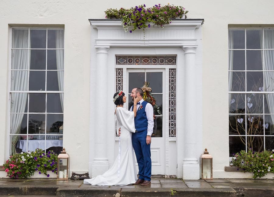 photo of an irish wedding couple posed beautifully outsite irish wedding venue Bellurgan Park in County Louth
